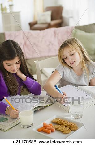 Two girls doing homework View Large Photo Image Stock Photo - Two girls doing homework. Fotosearch