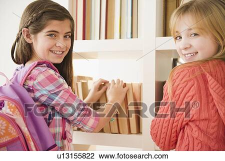 Two girls in library View Large Photo Image Stock Image - Two girls in library. Fotosearch