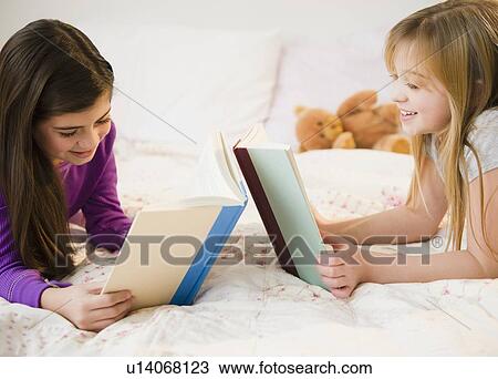 Two girls reading in bed View Large Photo Image Stock Image - Two girls reading in bed. Fotosearch