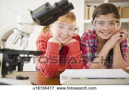 Two girls sitting in school lab View Large Photo Image Stock Photo - Two girls sitting in school lab. Fotosearch