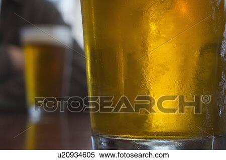 Two glasses of beer on table View Large Photo Image Stock Photography - Two glasses of beer on table. Fotosearch