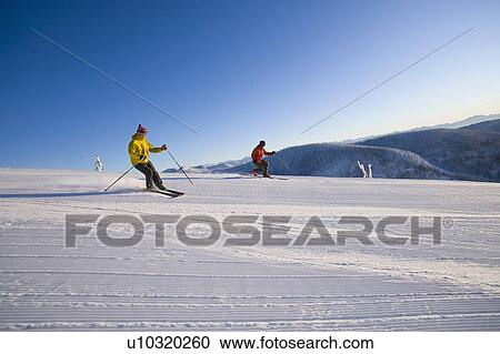 Stock Image - Two man on ski slope. Fotosearch