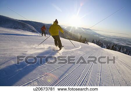 Stock Image - Two man on ski slope. Fotosearch
