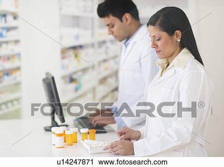 Two pharmacists in pharmacy View Large Photo Image Stock Image - Two pharmacists in pharmacy. Fotosearch