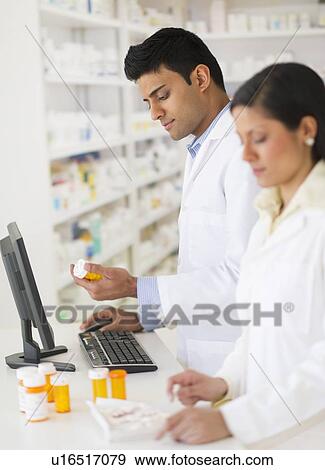 Two pharmacists in pharmacy View Large Photo Image Stock Photo - Two pharmacists in pharmacy. Fotosearch