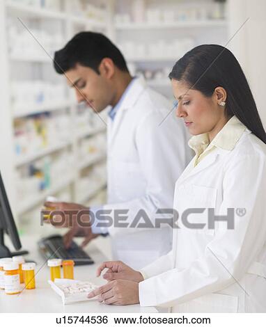 Two pharmacists in pharmacy View Large Photo Image Stock Photograph - Two pharmacists in pharmacy. Fotosearch