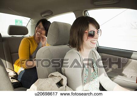Two young women travelling by car View Large Photo Image Stock Photo - Two young women travelling by car. Fotosearch