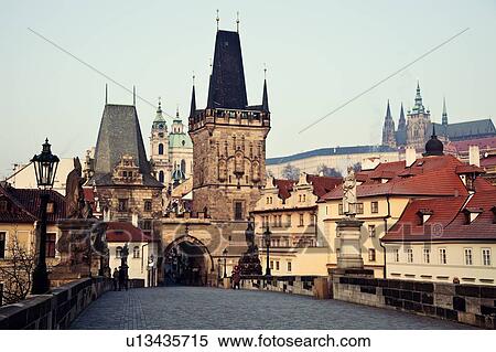 Stock Photography - View over Charles Bridge towards Prague Castle in early morning. Fotosearch
