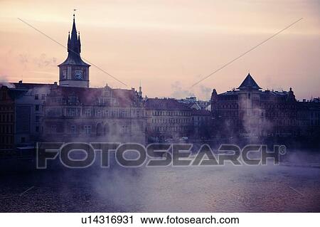 Stock Image - View over Vltava River towards Old Town at sunrise. Fotosearch