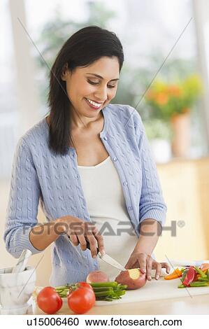 Woman cutting vegetables View Large Photo Image Stock Image - Woman cutting vegetables. Fotosearch
