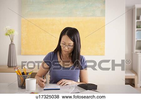 Woman doing paperwork View Large Photo Image Stock Photo - Woman doing paperwork. Fotosearch