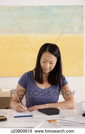 Stock Photo - Woman doing paperwork. Fotosearch