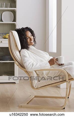 Woman drinking coffee in armchair in morning View Large Photo Image Stock Image - Woman drinking coffee in armchair in morning. Fotosearch