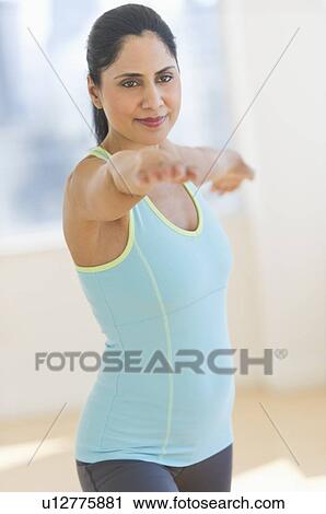 Woman exercising in fitness studio View Large Photo Image Stock Image - Woman exercising in fitness studio. Fotosearch