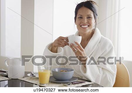 Woman having breakfast View Large Photo Image Stock Photo - Woman having breakfast. Fotosearch