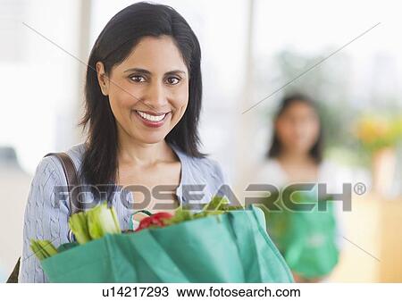 Woman holding bag of fresh vegetables View Large Photo Image Stock Image - Woman holding bag of fresh vegetables. Fotosearch