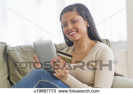 Woman holding credit card and digital tablet View Large Photo Image Stock Image - Woman holding credit card and digital tablet. Fotosearch