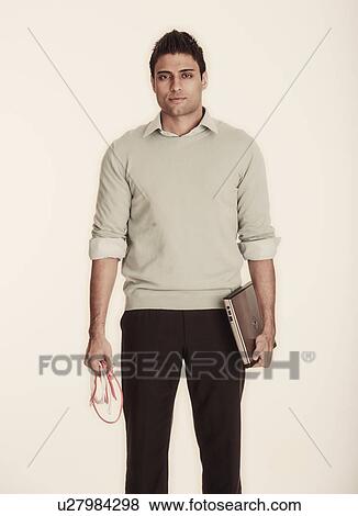 Stock Photo - Woman holding laptop and computer cable. Fotosearch