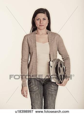 Stock Photo - Woman holding videotape. Fotosearch