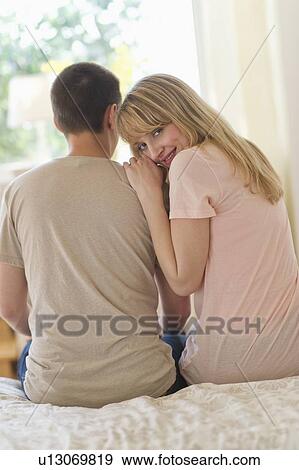 Woman leaning on men and looking over shoulder View Large Photo Image Stock Photo - Woman leaning on men and looking over shoulder. Fotosearch