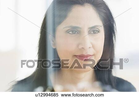 Woman looking through glass wall View Large Photo Image Stock Photography - Woman looking through glass wall. Fotosearch