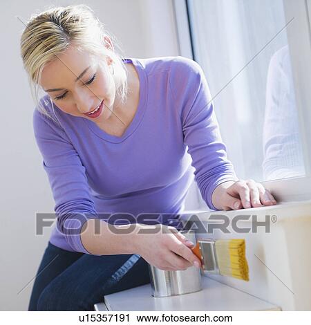 Woman painting window frame View Large Photo Image Stock Image - Woman painting window frame. Fotosearch
