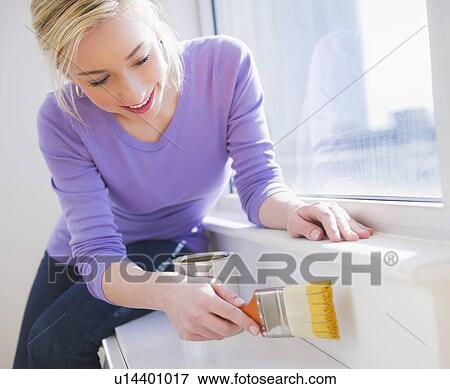 Woman painting window frame View Large Photo Image Stock Photo - Woman painting window frame. Fotosearch