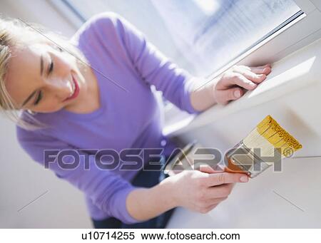 Woman painting window frame View Large Photo Image Stock Photography - Woman painting window frame. Fotosearch