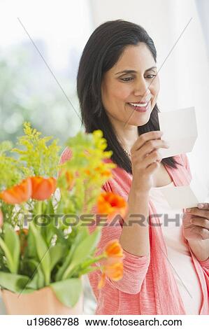 Woman reading note View Large Photo Image Stock Photo - Woman reading note. Fotosearch