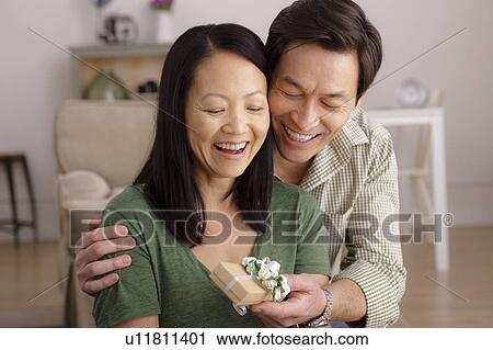Woman receiving gift from man View Large Photo Image Stock Image - Woman receiving gift from man. Fotosearch