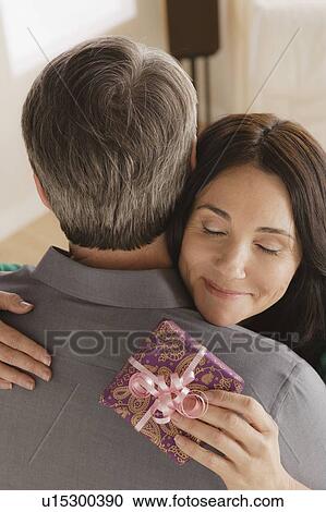 Woman receiving gift from man View Large Photo Image Stock Image - Woman receiving gift from man. Fotosearch
