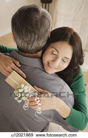 Woman receiving gift from man View Large Photo Image Stock Photo - Woman receiving gift from man. Fotosearch