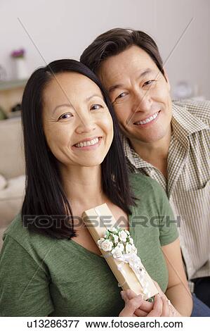 Woman receiving gift from man View Large Photo Image Stock Photo - Woman receiving gift from man. Fotosearch