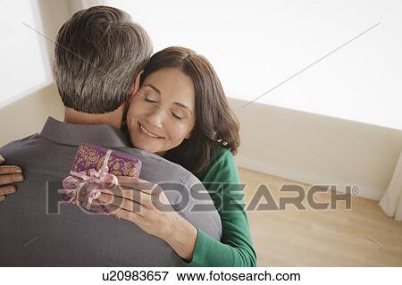 Woman receiving gift from man View Large Photo Image Stock Photo - Woman receiving gift from man. Fotosearch