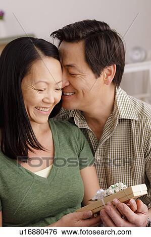 Woman receiving gift from man View Large Photo Image Stock Photograph - Woman receiving gift from man. Fotosearch