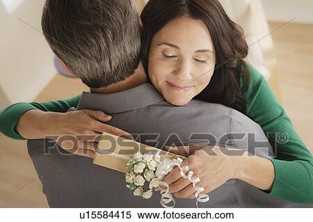 Stock Photography - Woman receiving gift from man. Fotosearch