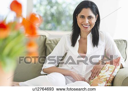 Woman relaxing on sofa View Large Photo Image Stock Image - Woman relaxing on sofa. Fotosearch