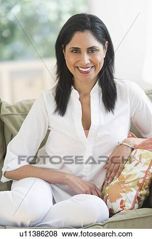 Woman relaxing on sofa View Large Photo Image Stock Photo - Woman relaxing on sofa. Fotosearch