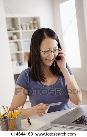 Woman shopping online from home View Large Photo Image Stock Image - Woman shopping online from home. Fotosearch