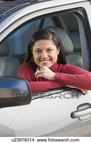 Woman sitting in her new car View Large Photo Image Picture - Woman sitting in her new car. Fotosearch
