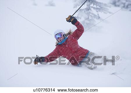 Picture - Woman skiing powder . Fotosearch