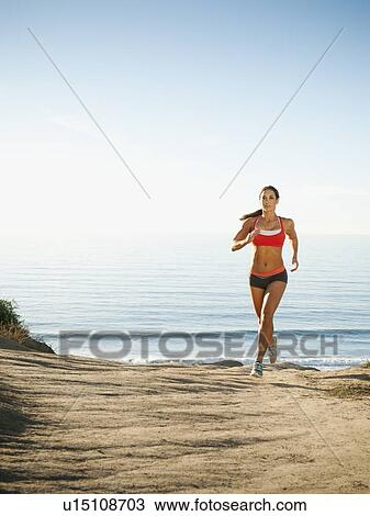 Woman training on coast View Large Photo Image Stock Image - Woman training on coast. Fotosearch