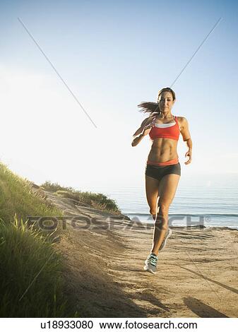 Woman training on coast View Large Photo Image Stock Image - Woman training on coast. Fotosearch