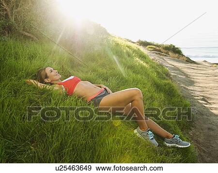 Stock Photo - Woman training on coast. Fotosearch