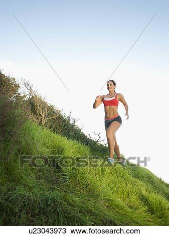 Woman training on hill View Large Photo Image Stock Image - Woman training on hill. Fotosearch