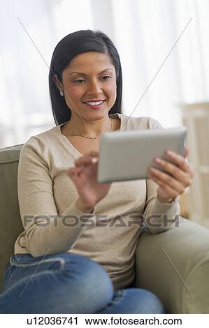 Woman using digital tablet View Large Photo Image Stock Image - Woman using digital tablet. Fotosearch