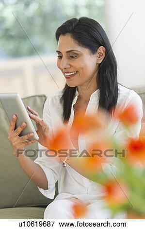 Woman using digital tablet View Large Photo Image Stock Photo - Woman using digital tablet. Fotosearch