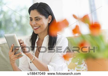 Woman using digital tablet View Large Photo Image Stock Photo - Woman using digital tablet. Fotosearch