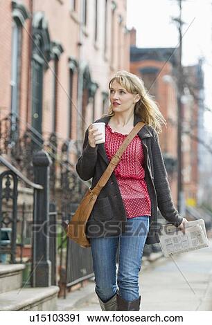 Stock Image - Woman walking on street. Fotosearch