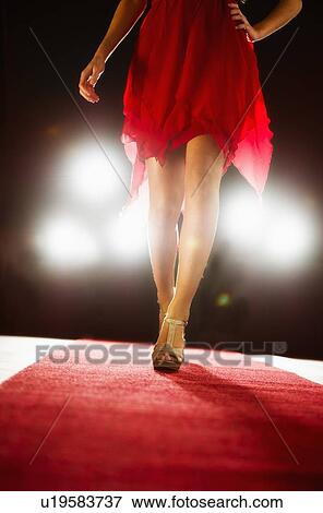 Woman wearing red dress on catwalk View Large Photo Image Stock Photo - Woman wearing red dress on catwalk. Fotosearch